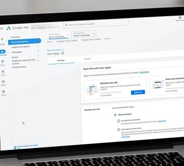 Laptop screen showing a Google Ads dashboard with the Recommendations tab open and navigation on the left, displaying campaign options and auto-apply settings.