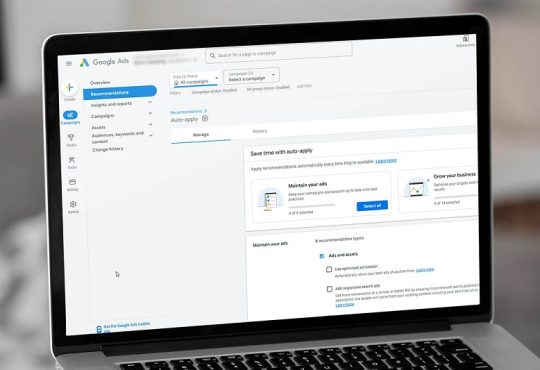 Laptop screen showing a Google Ads dashboard with the Recommendations tab open and navigation on the left, displaying campaign options and auto-apply settings.